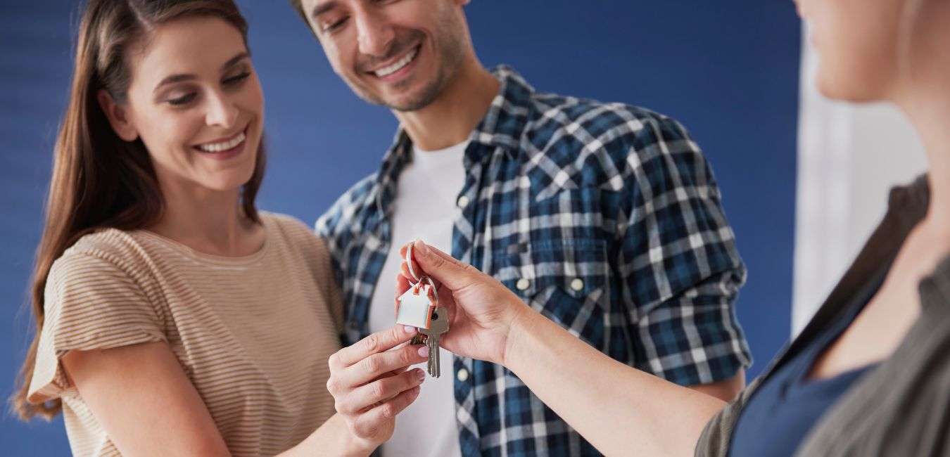 Couple receiving keys to new condo